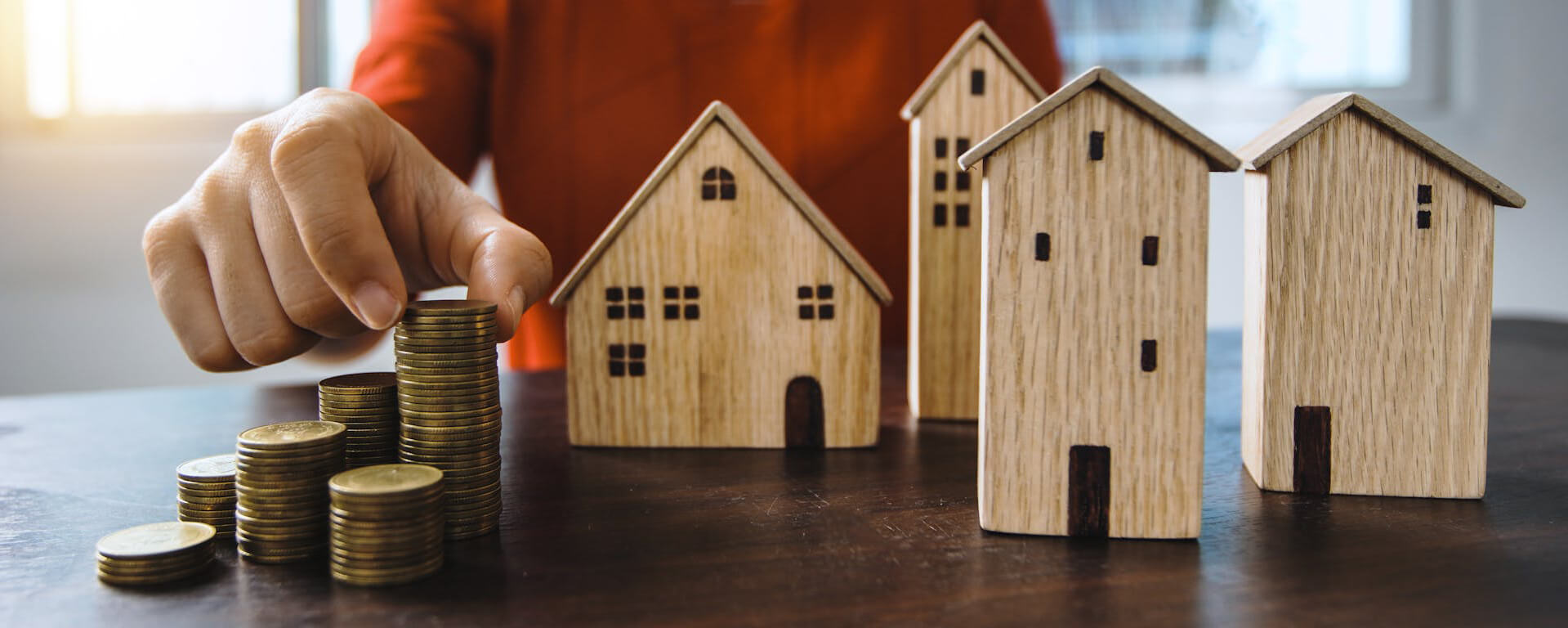 holding coin with house