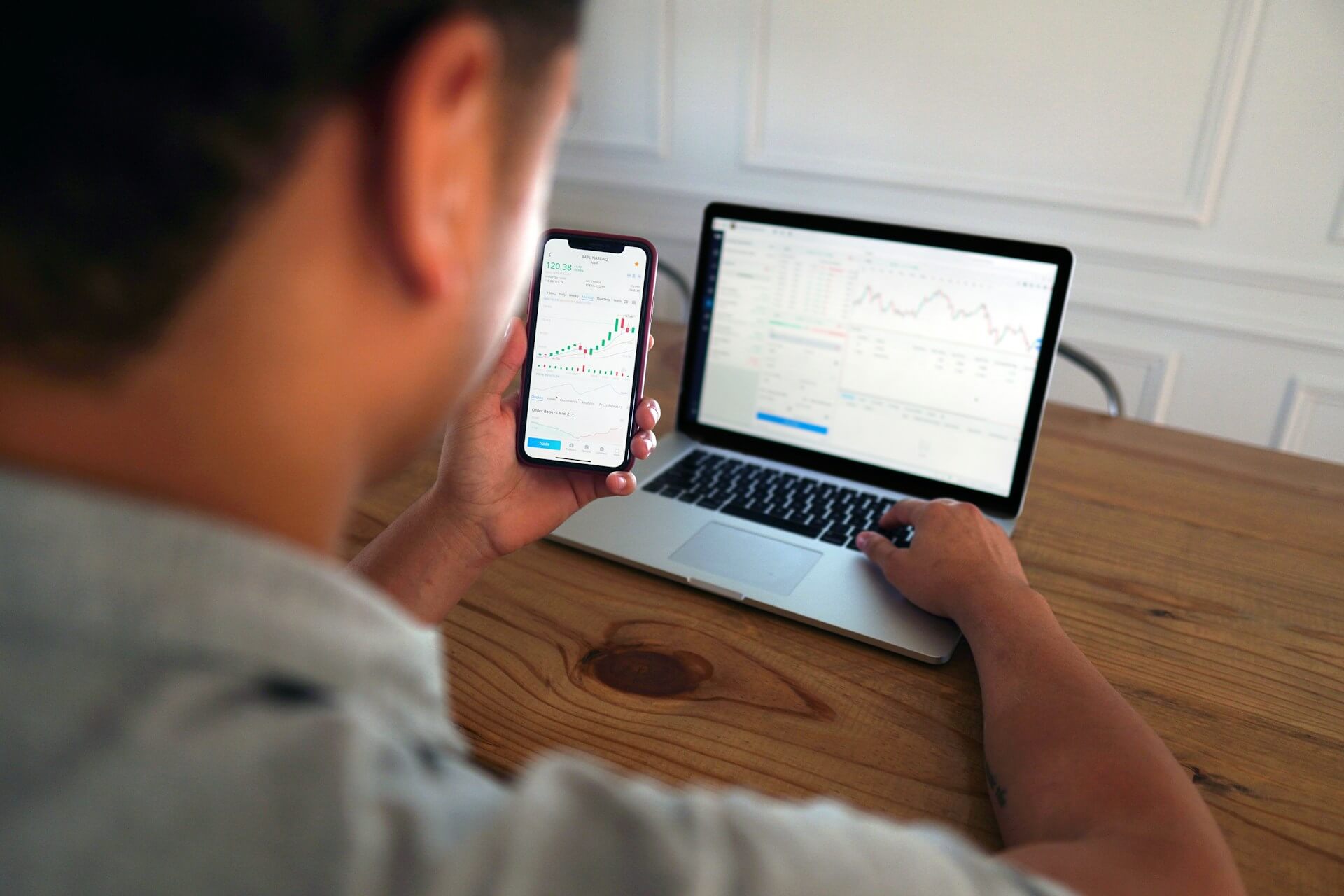 A man analyzes stock market data on devices.| SGS Mortgage